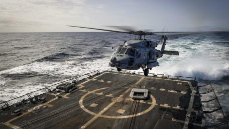 Military Helicopter in Action Above the Waves wallpaper
