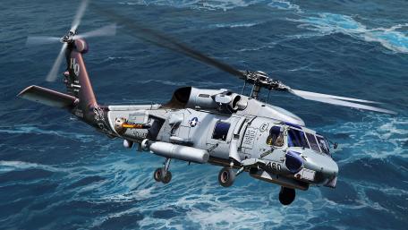 Military Helicopter in Action Over Ocean Waves wallpaper