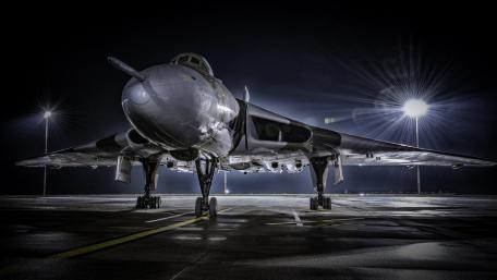 Majestic Military Aircraft Under Night Lights wallpaper