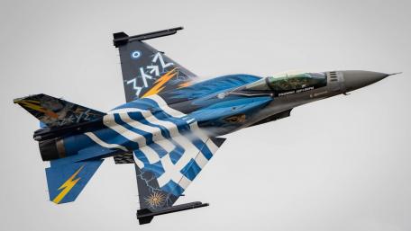 Fighter Jet in Dynamic Flight Displaying Creative Camouflage Design wallpaper