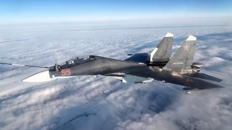 Sleek Military Aircraft in Flight Above the Clouds wallpaper