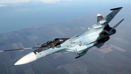 Fighter Jet in Action Over Fields wallpaper