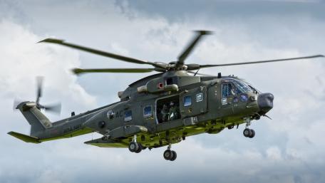Military Helicopter in Action Above the Clouds wallpaper