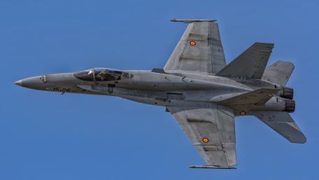 Fighter Jet Captured in Flight Over Blue Sky wallpaper
