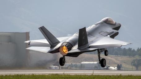 Futuristic Fighter Jet in Action wallpaper