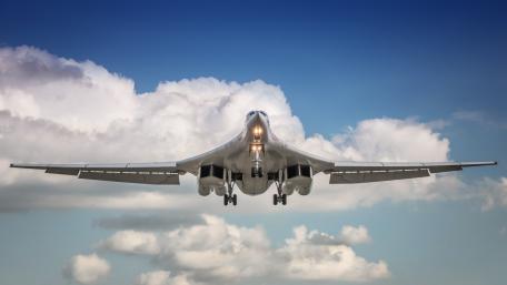 Military Aircraft in Flight Above Clouds wallpaper