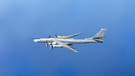 Military Aircraft in Flight Over Blue Sky wallpaper