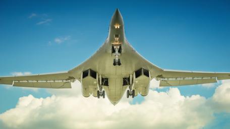 Sleek Military Aircraft Against a Blue Sky wallpaper