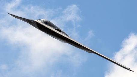Stealth Aircraft Flying Above the Clouds wallpaper