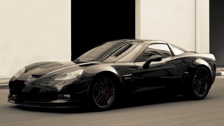 Sleek Black Corvette in Urban Setting wallpaper