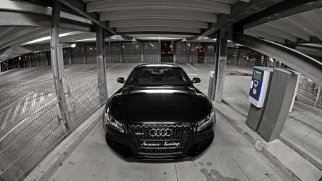 Sleek Black Audi in Urban Garage Setting wallpaper
