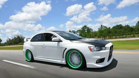 Sleek White Car with Green Accents on the Road wallpaper