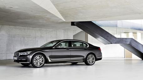 Sleek Luxury Sedan in Modern Architecture wallpaper