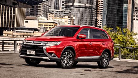 Sleek Red SUV in Urban Setting wallpaper