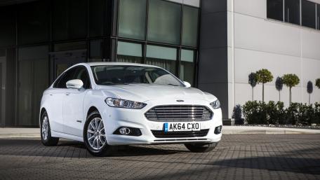Sleek White Car in Urban Setting wallpaper