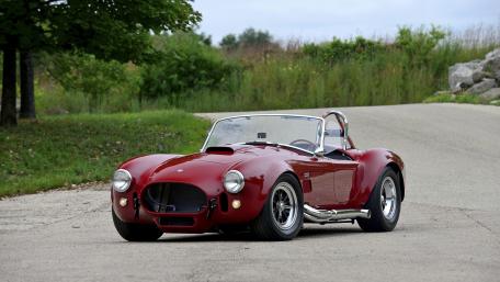 Classic Red Sports Car on a Scenic Road wallpaper