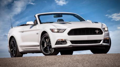 Sleek White Mustang Convertible Under Blue Skies wallpaper