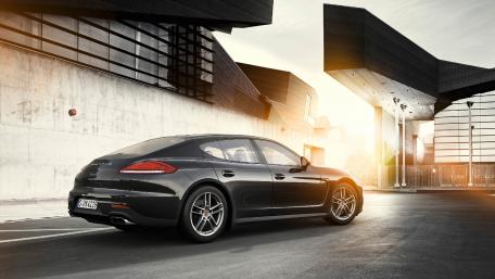 Sleek Black Car in Modern Urban Setting wallpaper