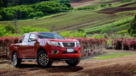 Vibrant Nissan Pickup Amidst Lush Vineyard Landscape wallpaper