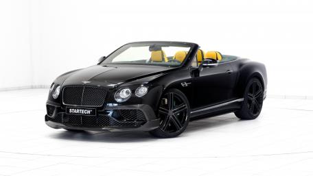 Sleek Black Convertible with Yellow Interior wallpaper