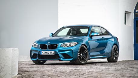 Sleek Blue BMW M2 in Urban Setting wallpaper