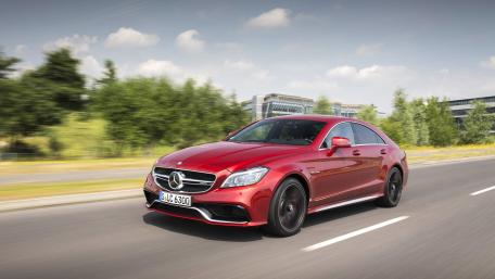 Sleek Red Luxury Car on the Move wallpaper