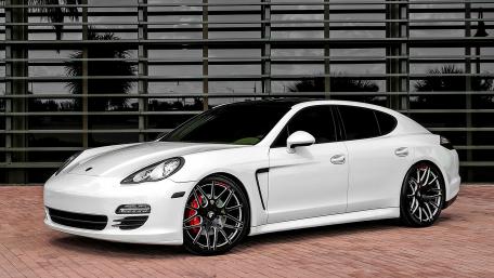 Sleek White Sports Sedan on Display wallpaper
