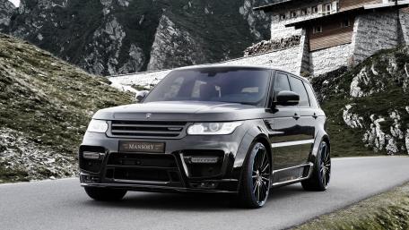 Sleek Luxury SUV on Mountain Road wallpaper