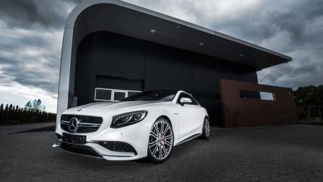 Sleek White Luxury Car in Modern Setting wallpaper