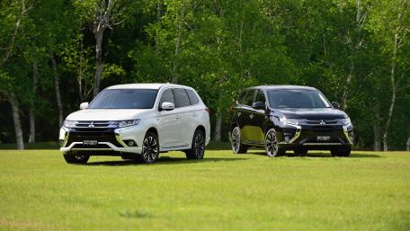 Stylish Mitsubishi SUVs in Nature Scene wallpaper