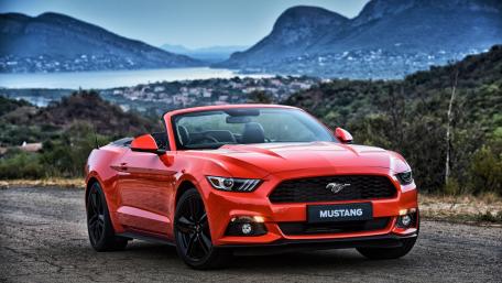 Vibrant Mustang Cabriolet Amid Scenic Landscapes wallpaper