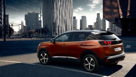 Modern SUV in Urban Setting with Skyline Views wallpaper