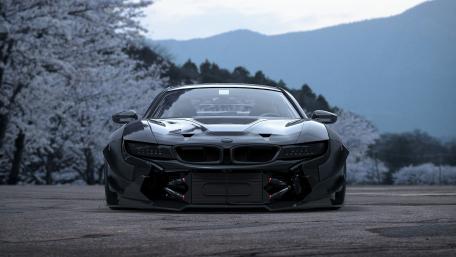 Sleek Black BMW at Dawn in Scenic Landscape wallpaper