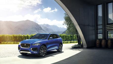 Dynamic Blue SUV in a Scenic Setting wallpaper