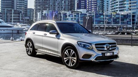 Sleek Silver Luxury SUV by the Water wallpaper