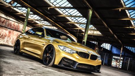 Sleek Golden BMW in Urban Setting wallpaper