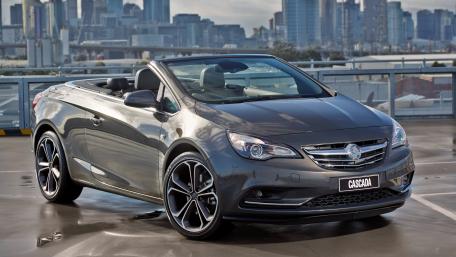 Sleek Convertible in Urban Landscape wallpaper