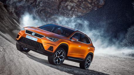 Dynamic Orange SUV on Rugged Terrain Wallpaper wallpaper