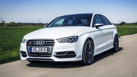 Sleek White Audi Driving on Open Road wallpaper