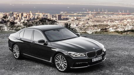 Sleek BMW Surrounded by Urban Panorama wallpaper