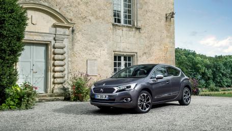 Sleek Car Outside Historic Building wallpaper