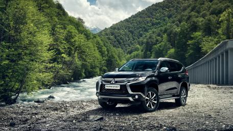 Sleek SUV by the Riverbank wallpaper