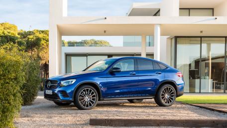 Sleek Blue Luxury SUV in Modern Setting wallpaper
