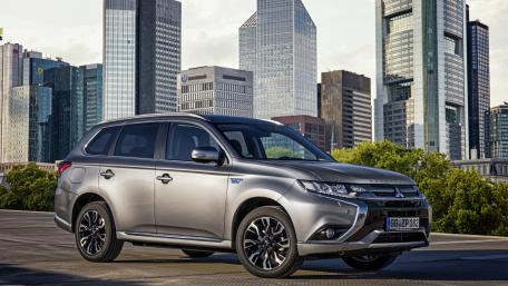 Sleek City SUV Against Urban Landscape wallpaper