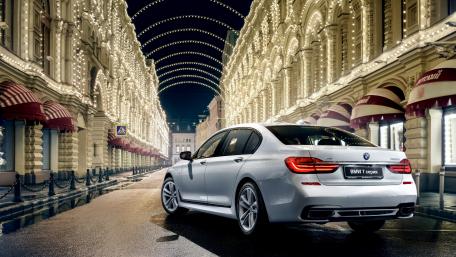 Sleek BMW in a Festive City Setting wallpaper