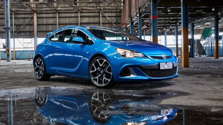 Sleek Blue Car in Industrial Setting wallpaper