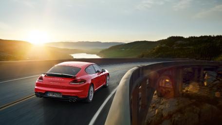 Sleek Red Car on Scenic Mountain Road wallpaper