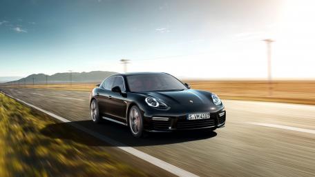 Sleek Black Sports Car on an Open Road wallpaper