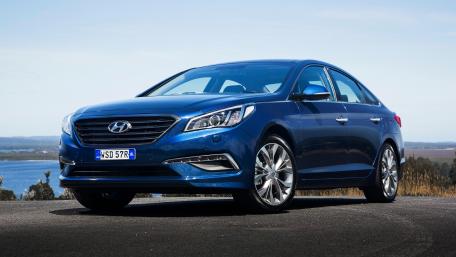 Sleek Blue Sedan in Stunning Landscape wallpaper