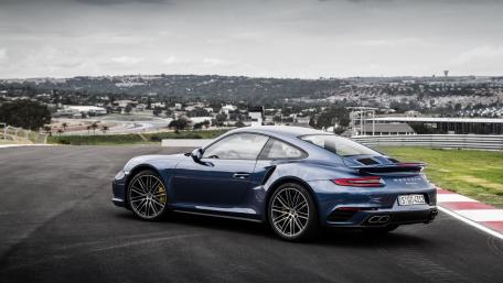 Sleek Blue Sports Car on a Grand Track wallpaper
